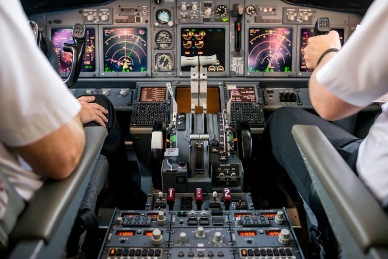 pilot and assistant pilot in the plane cockpit
